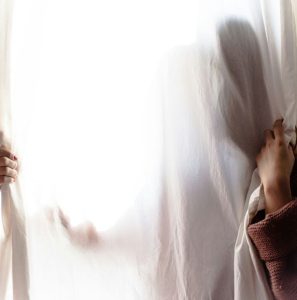 EMDR Anxious person hiding behind a sheer curtain